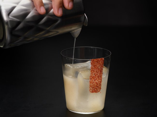 cocktail of coffee bitters, coffee liquor, passionfruit cordial, and tonic